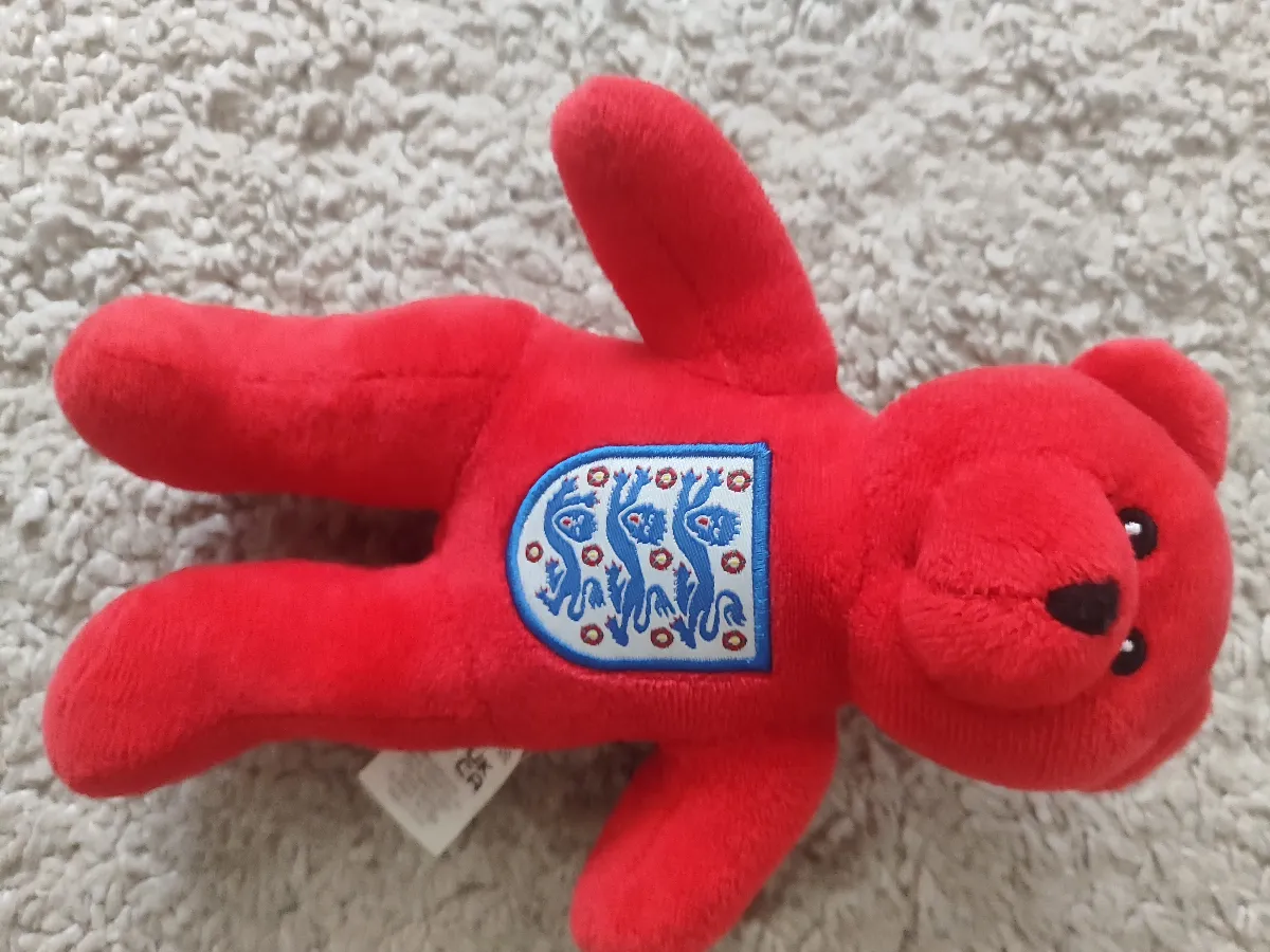 A red England teddy bear with the Three Lions badge